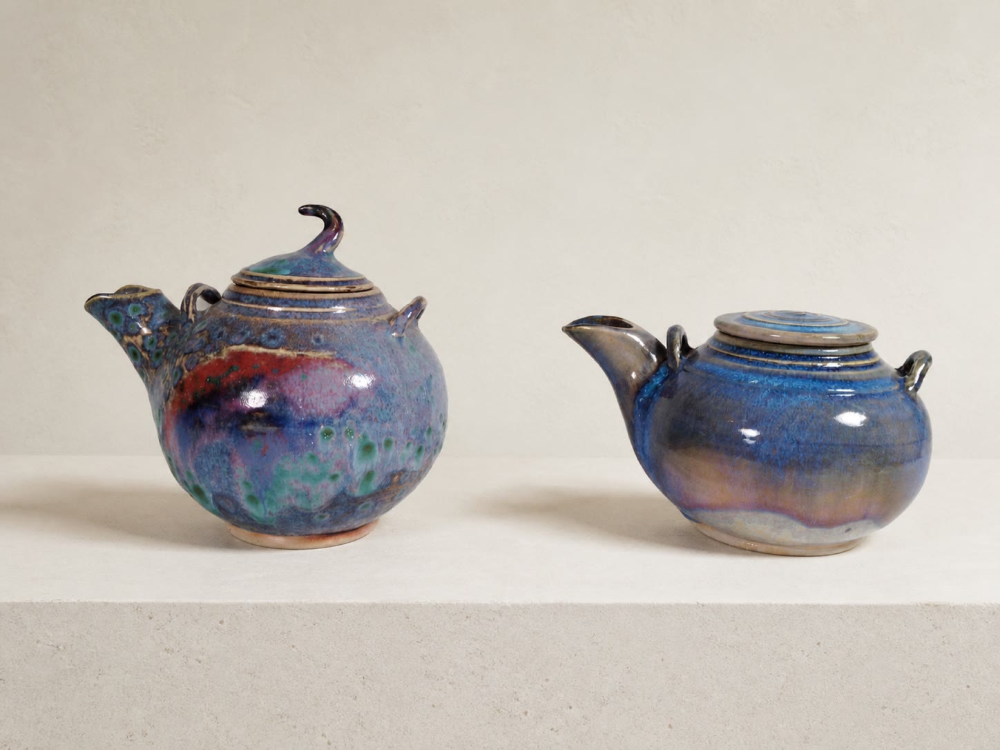 Two richly glazed ceramic teapots